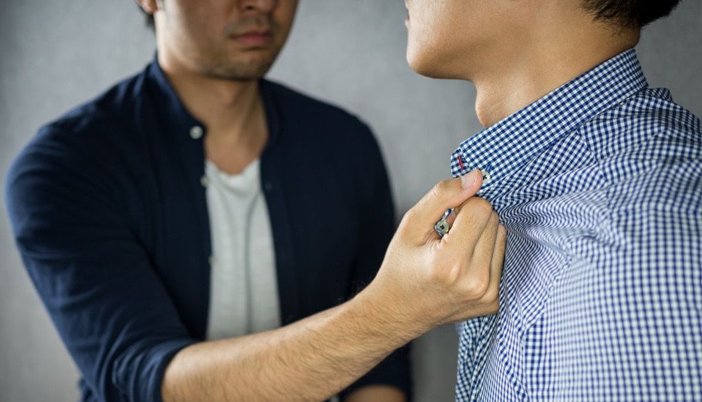 Man grab other by the collar, having argument stock photo