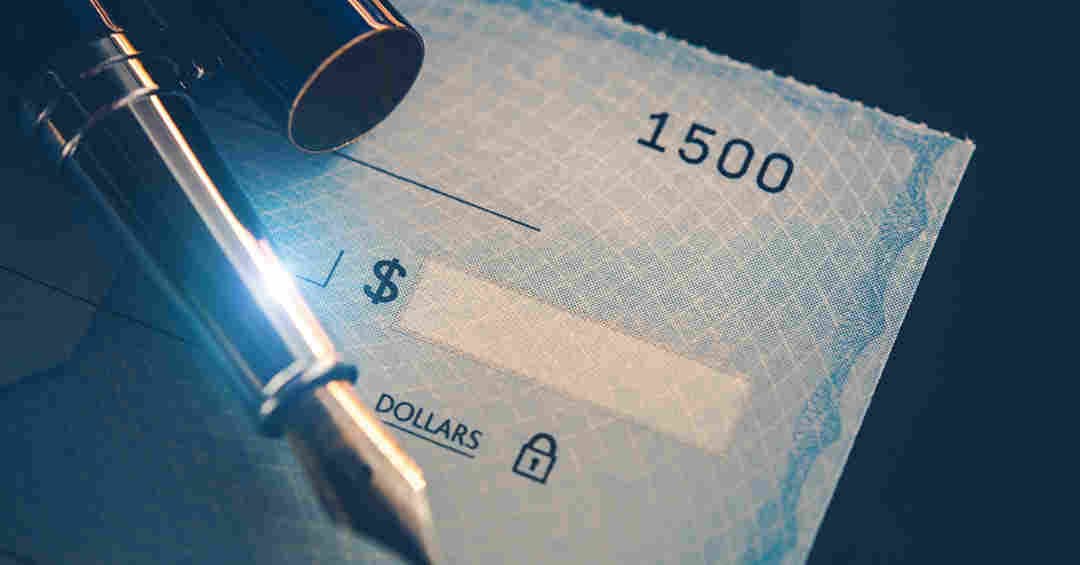 image of a check and pen